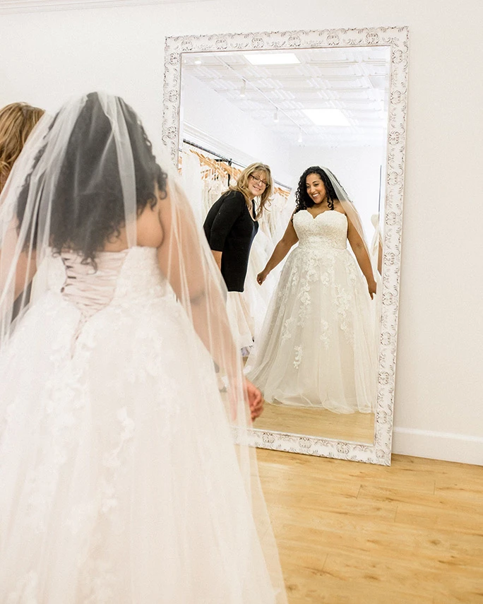 Alex LaRosa trying on a Stella York Wedding Dress style 6745