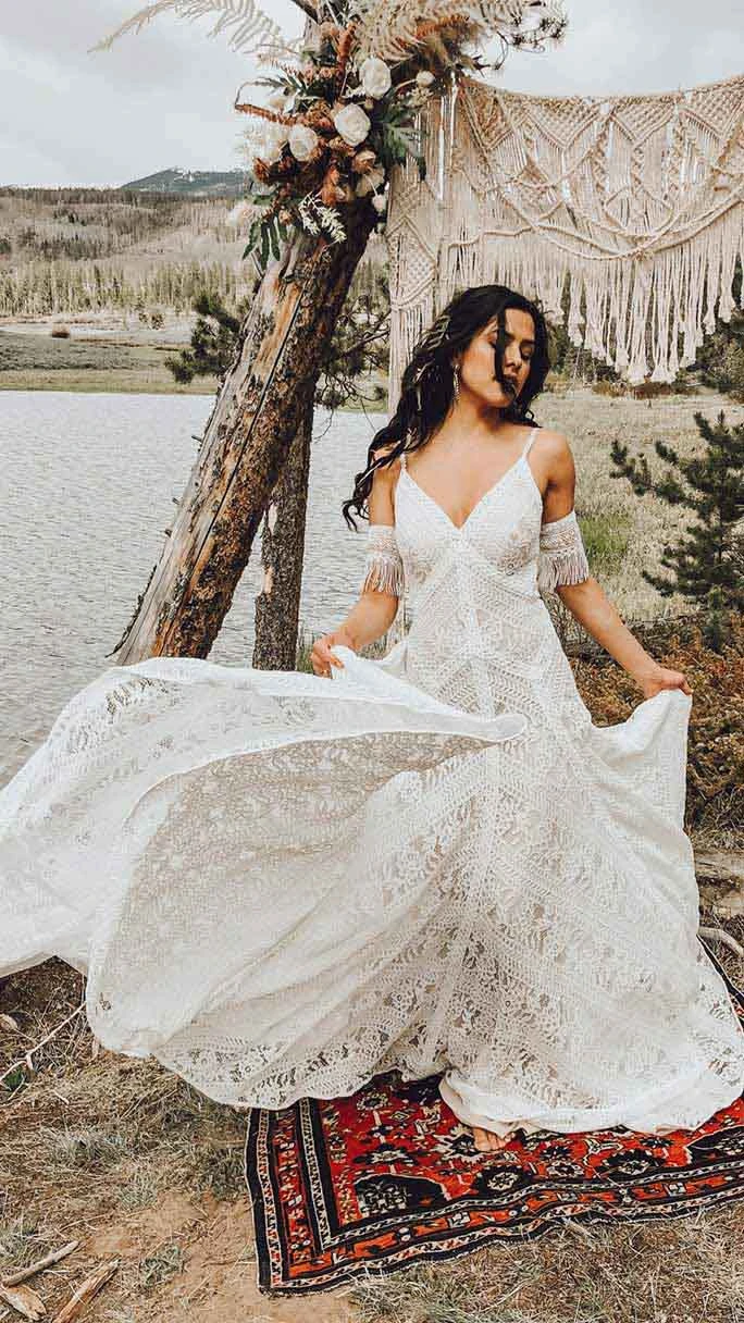 A Bride dancing in her Reece wedding dress from All Who Wander, paired with an effortless looking hair headpiece