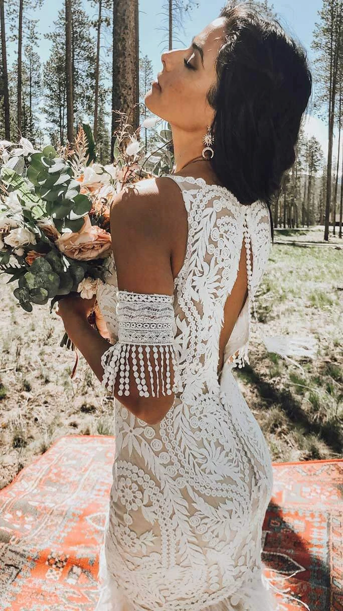 Boho bride outdoors wearing her Rowen wedding dress from All Who Wander.