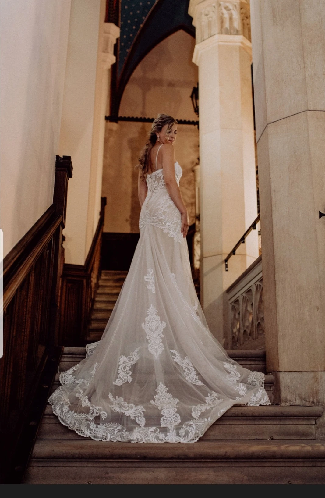 True Bride Alison walking up the stairs at the Marienburg Castle in Germany, wearing her Essense of Australia wedding dress, style D2819