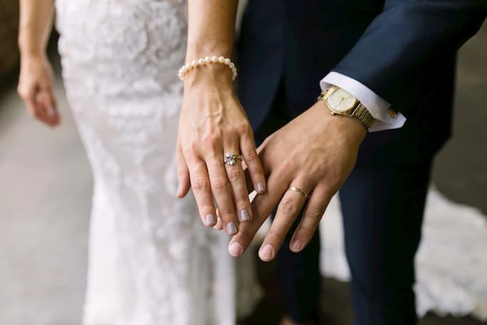 true bride Catie and husband showing their wedding rings