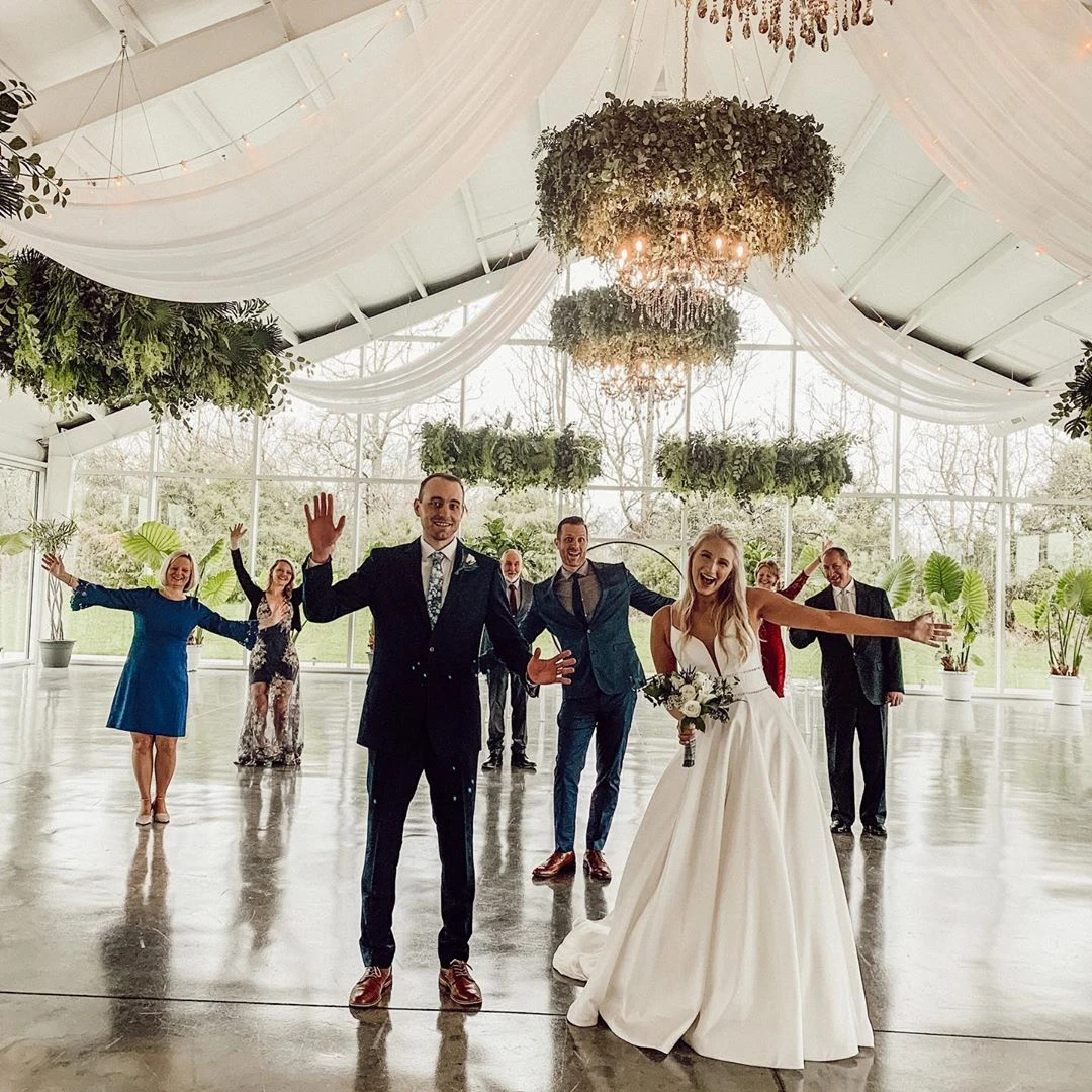 bride and groom posing for photo at wedding ceremony