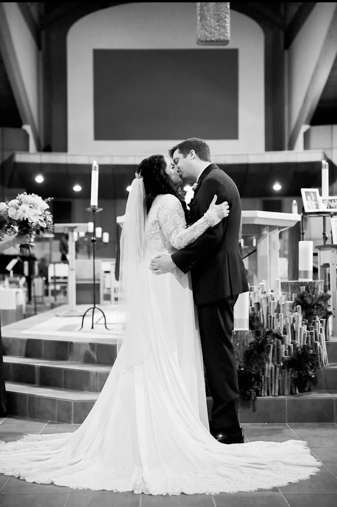 True bride Julia and husband Greg sharing a kiss on their wedding day