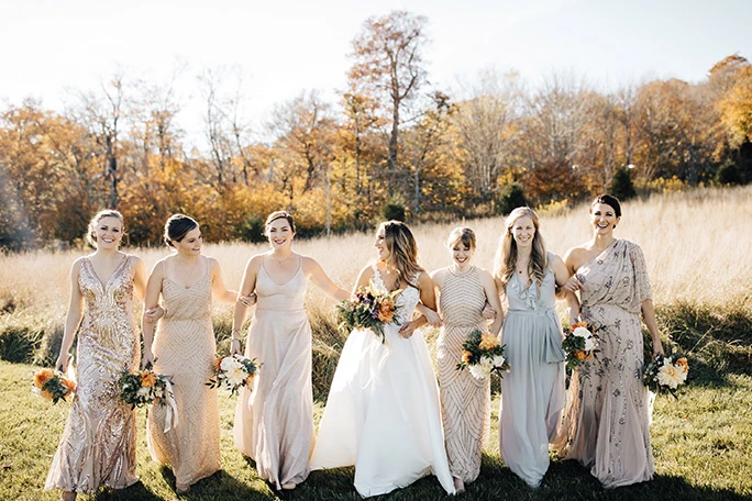 True Society Bride with her wedding party wearing golden bridesmaid dresses