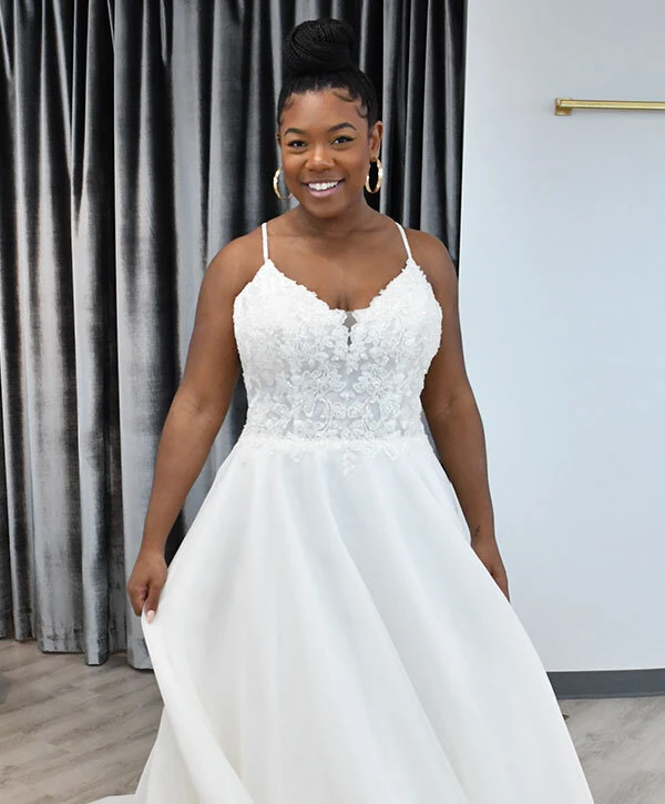 Woman of color bride wearing a v-neck lace, a-line wedding dress from designer Oxford Street. Style PA1184.