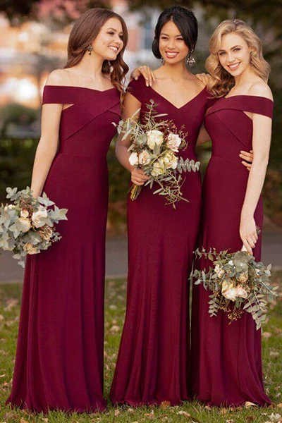 3 bridesmaids wearing matching Sorella Vita garnet colored, double knit dresses.