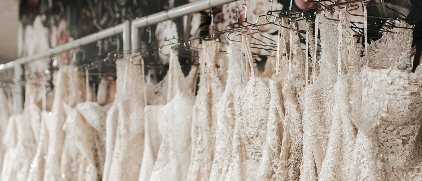 Rack of gorgeous wedding dresses at our True Society by Belle Vogue Bridal shop in Lenexa, Kansas.