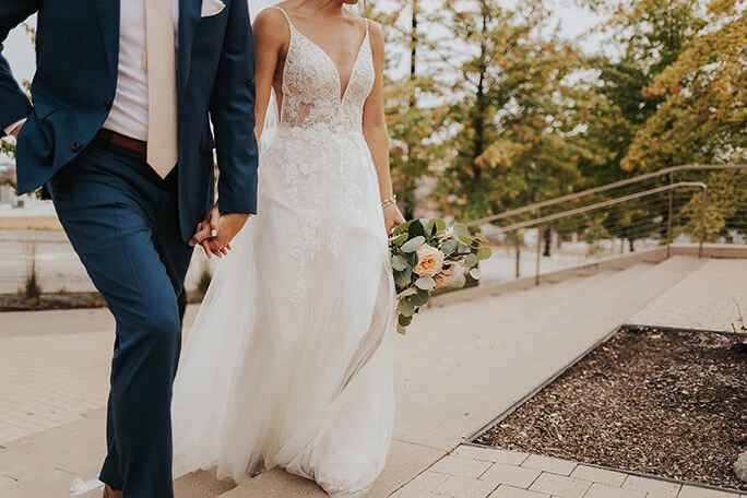 real bride holding hands with husband - style D2840 by essense of australia