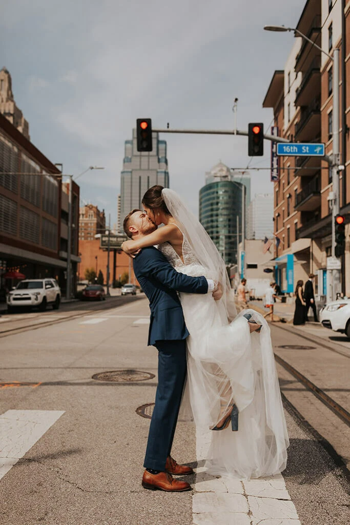 bride and groom sharing a kiss in the city - style D2840 by all who wander
