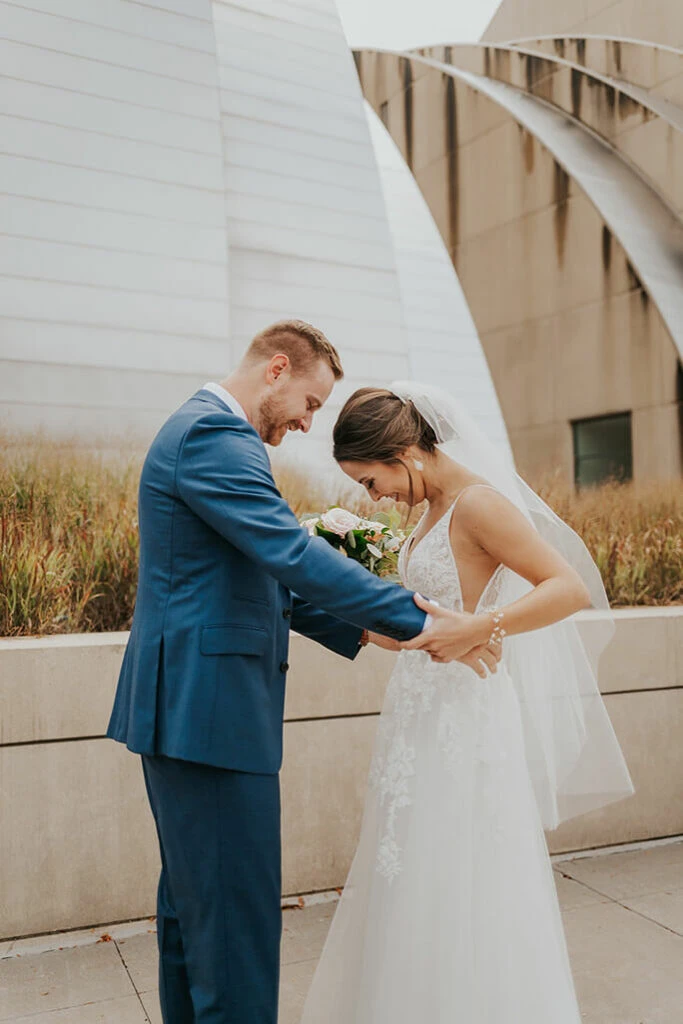 bride and groom at kauffman center in kansas city - style D2840 by essense of australia
