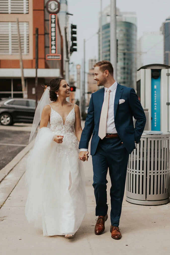 bride and groom walking in the city - style D2840 by essense of australia