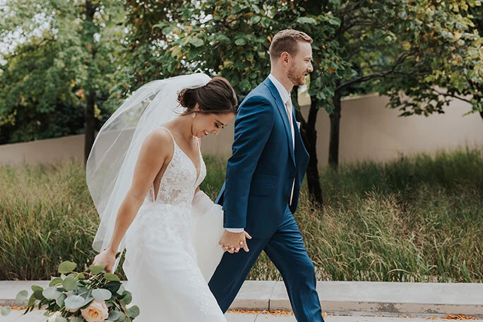 real bride Katie and husband holding hands - style d2840 by essense of australia