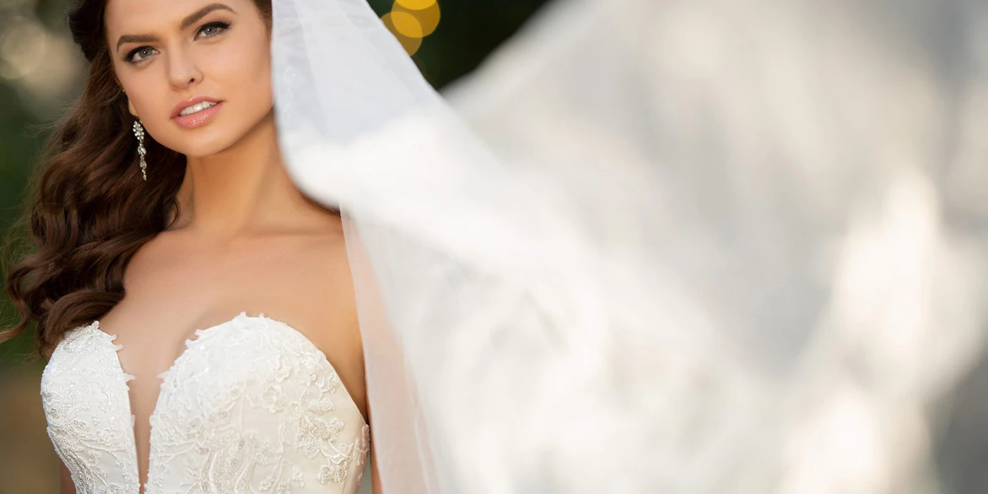 True Society bride wearning a strapless, lace wedding dress and a billowing veil