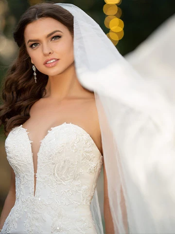 True Society bride wearning a strapless, lace wedding dress and a billowing veil