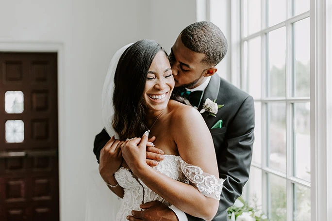 Couple hugging, bride wearing essense of australia off the shoulder lace gown, d2988