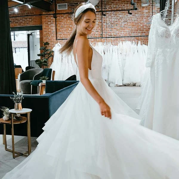 A bride tries on a simple wedding dress at True Society by Belle Vogue Bridal Crossroads
