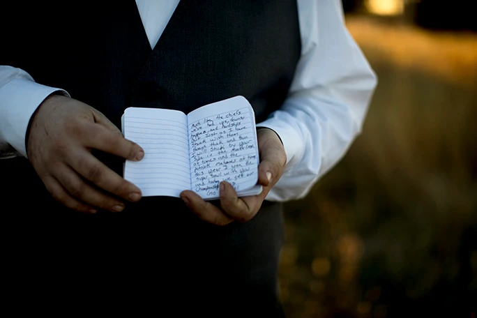 groom holding vows 