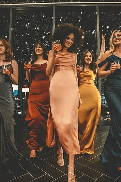 Bridesmaids wearing sleek charmeuse, floor-length gowns from designer Sorella Vita.