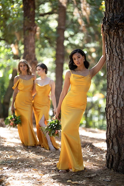 3 bridesmaids wearing harvest gold colored charmeuse dresses.