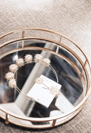 Bridal headband and hair pins in a jewelry display tray.