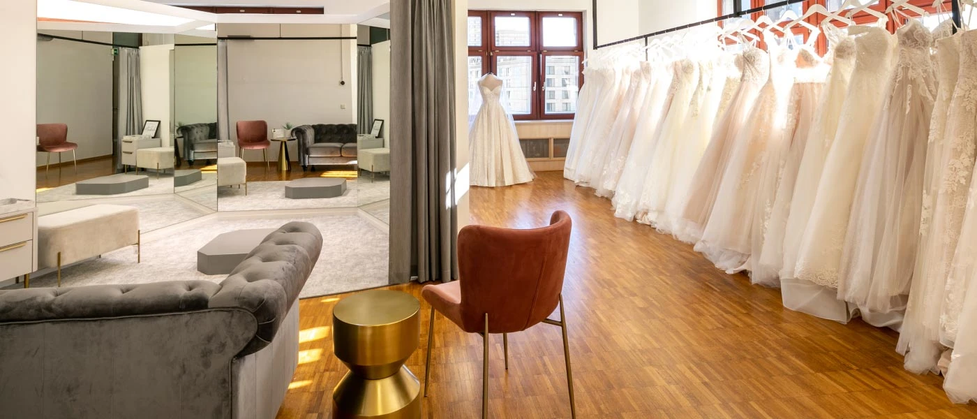 Fitting room viewing area and rack of wedding dresses at our True society bridal store in Berlin Mitte.