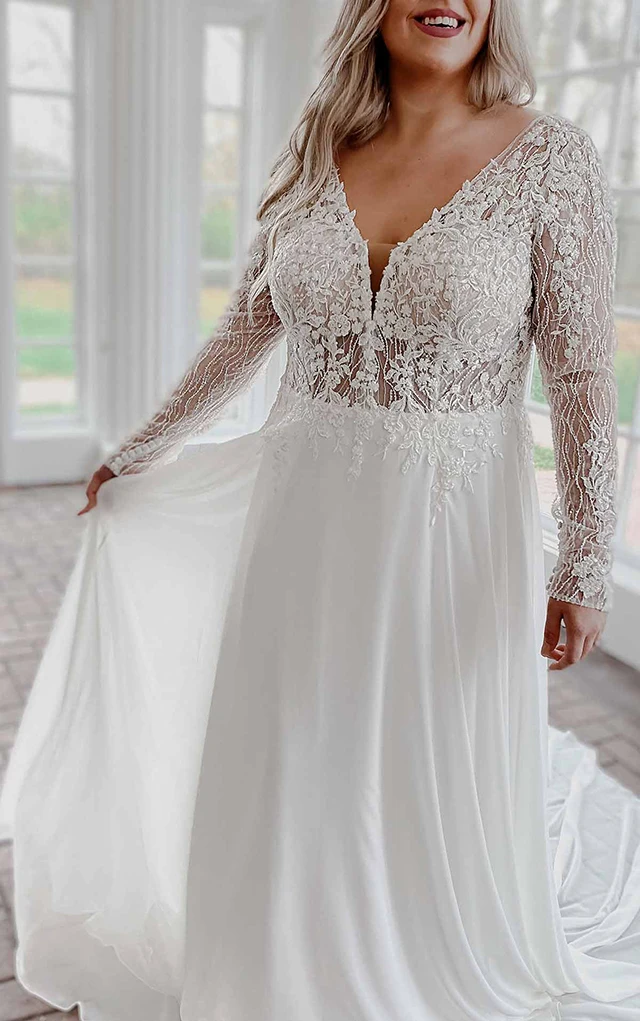 bride holding out skirt of wedding gown, wearing stella york 7291