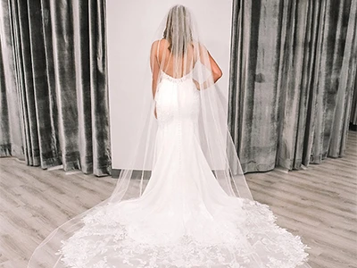 back view of fit and flare wedding gown with long veil