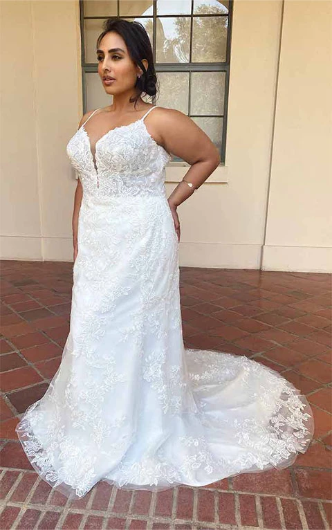 Bride wearing sophisticated sheath spaghetti strap all over floral lace wedding gown