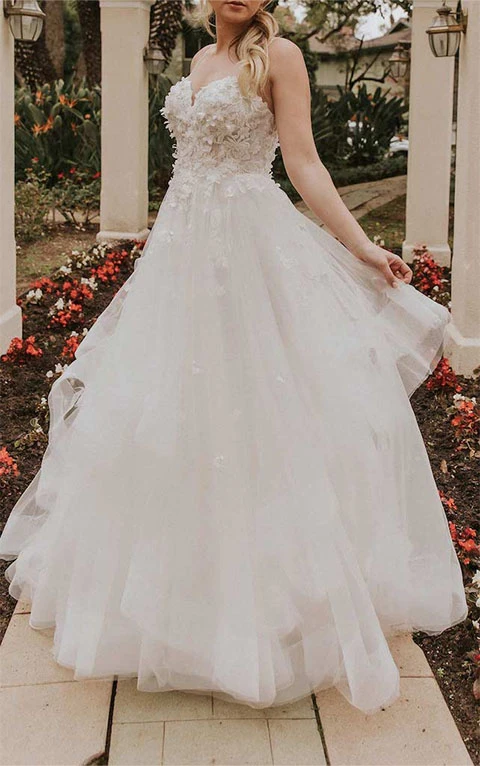 Bride wearing princess style layered tulle gown with lace bodice