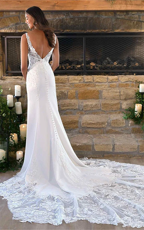 Bride wearing satin wedding dress with lace bodice and train