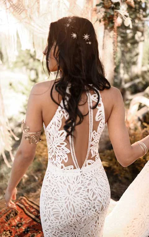 Bohemian bride wears high-neck lace wedding dress with open back detail and gold bridal hairpins.