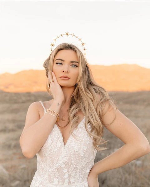 Bride wears stars headband veil alternative and beaded lace wedding dress.