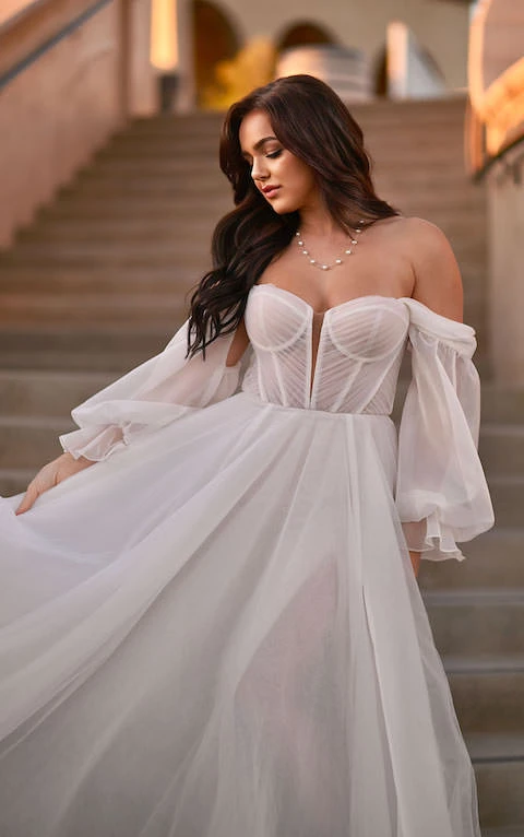 Bride wearing bohemian off the shoulder long sleeve wedding dress