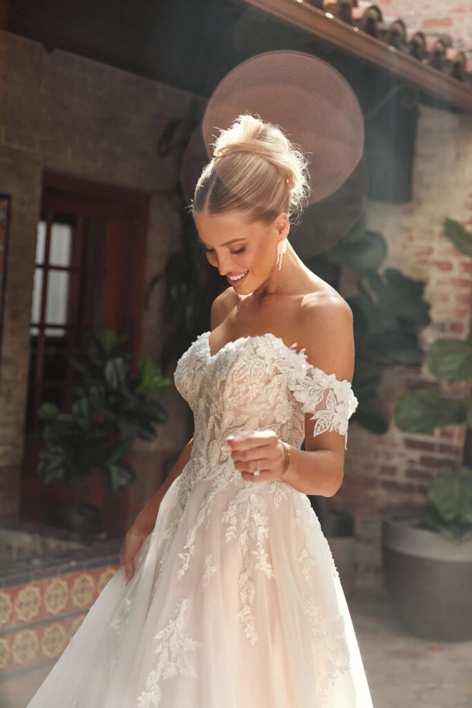 Bride wearing an off the shoulder lace wedding dress 