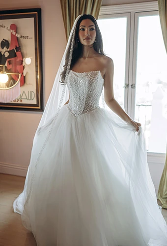 Bride wearing Stella York style SY8312, a pearl-beaded strapless corset ballgown with a voluminous tulle skirt