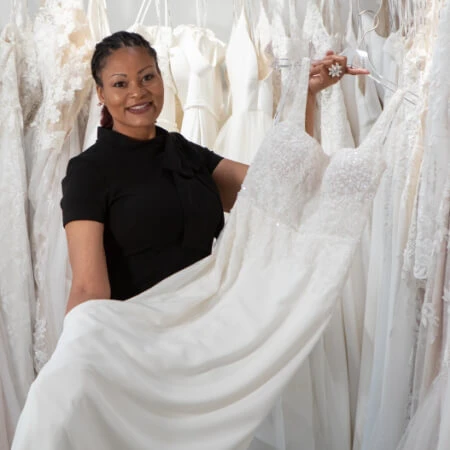 Stylist presenting wedding gown