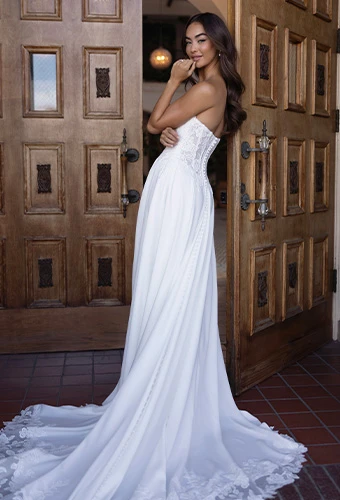 Bride wearing strapless a-line chiffon wedding dress with lace details