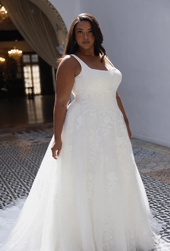 Plus size bride wearing lace a-line wedding dress with square neckline and shoulder straps