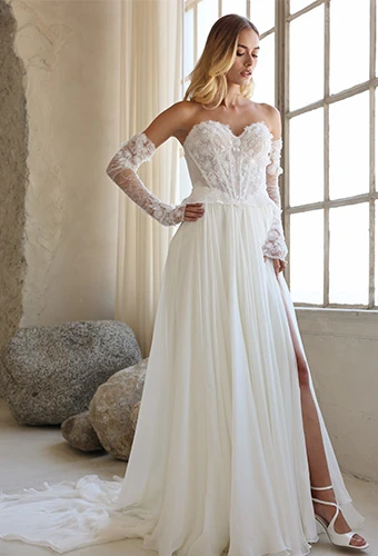 Bride wearing strapless chiffon wedding dress with lace bodice and high leg slit
