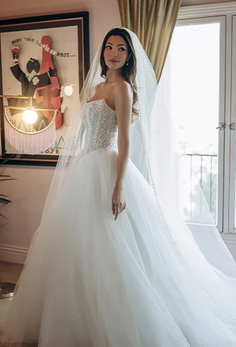 Bride wearing strapless tulle ballgown wedding dress with pearl beaded bodice