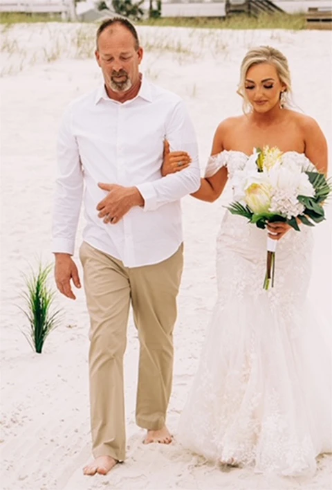 Danielle and father walking down the aisle on beach