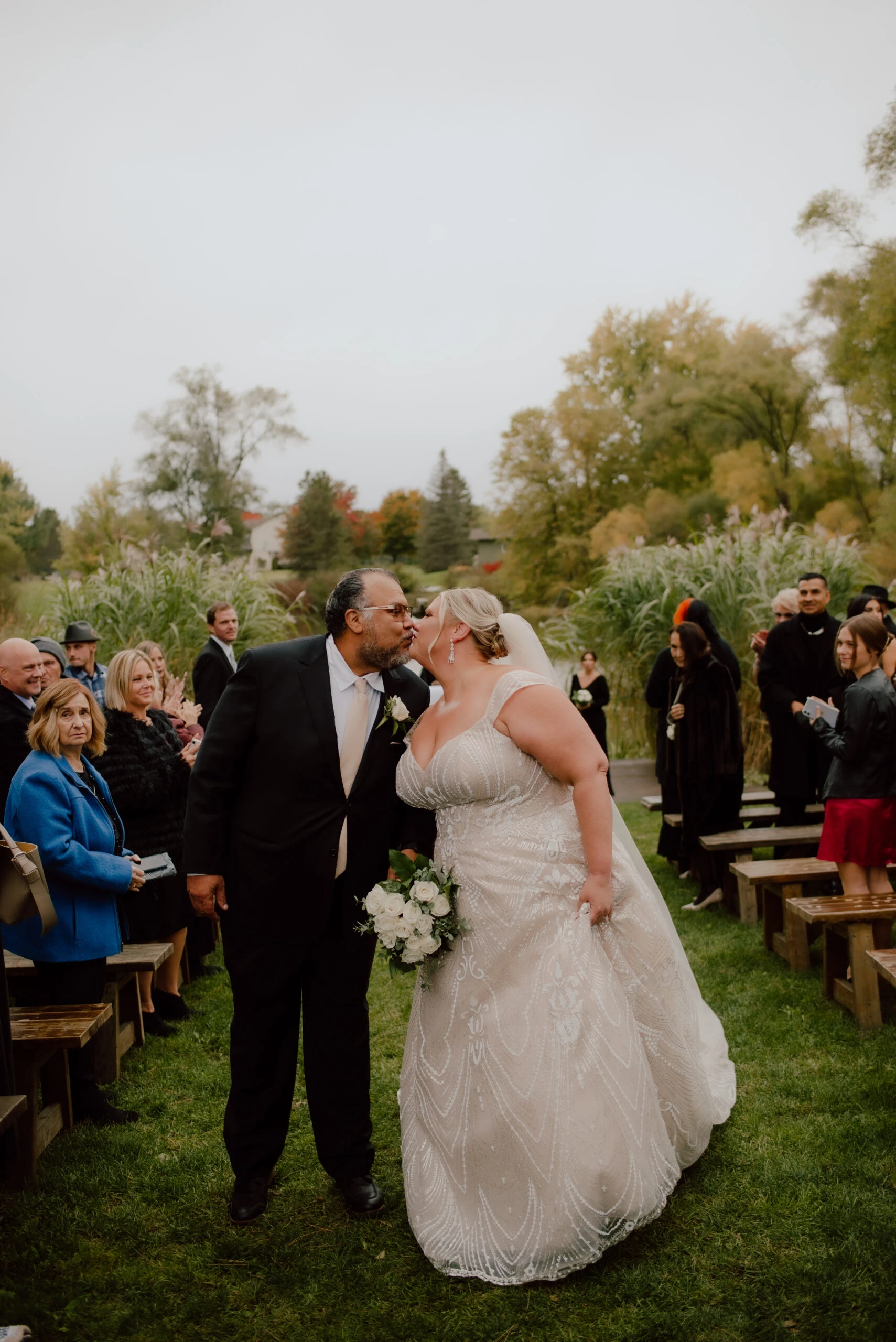 True Bride Meighan and Groom Andres Kissing walking Down the Aisle