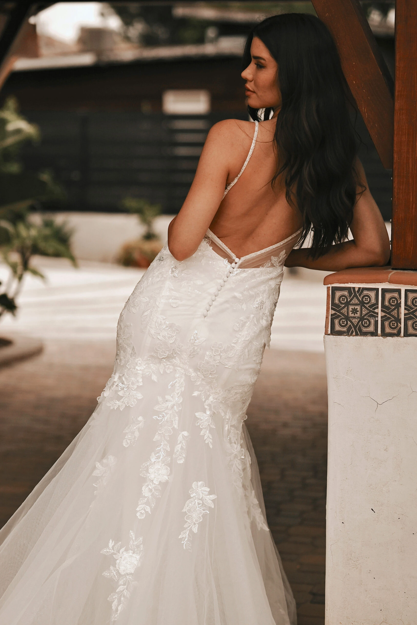 Bride wearing a low back lace wedding dress