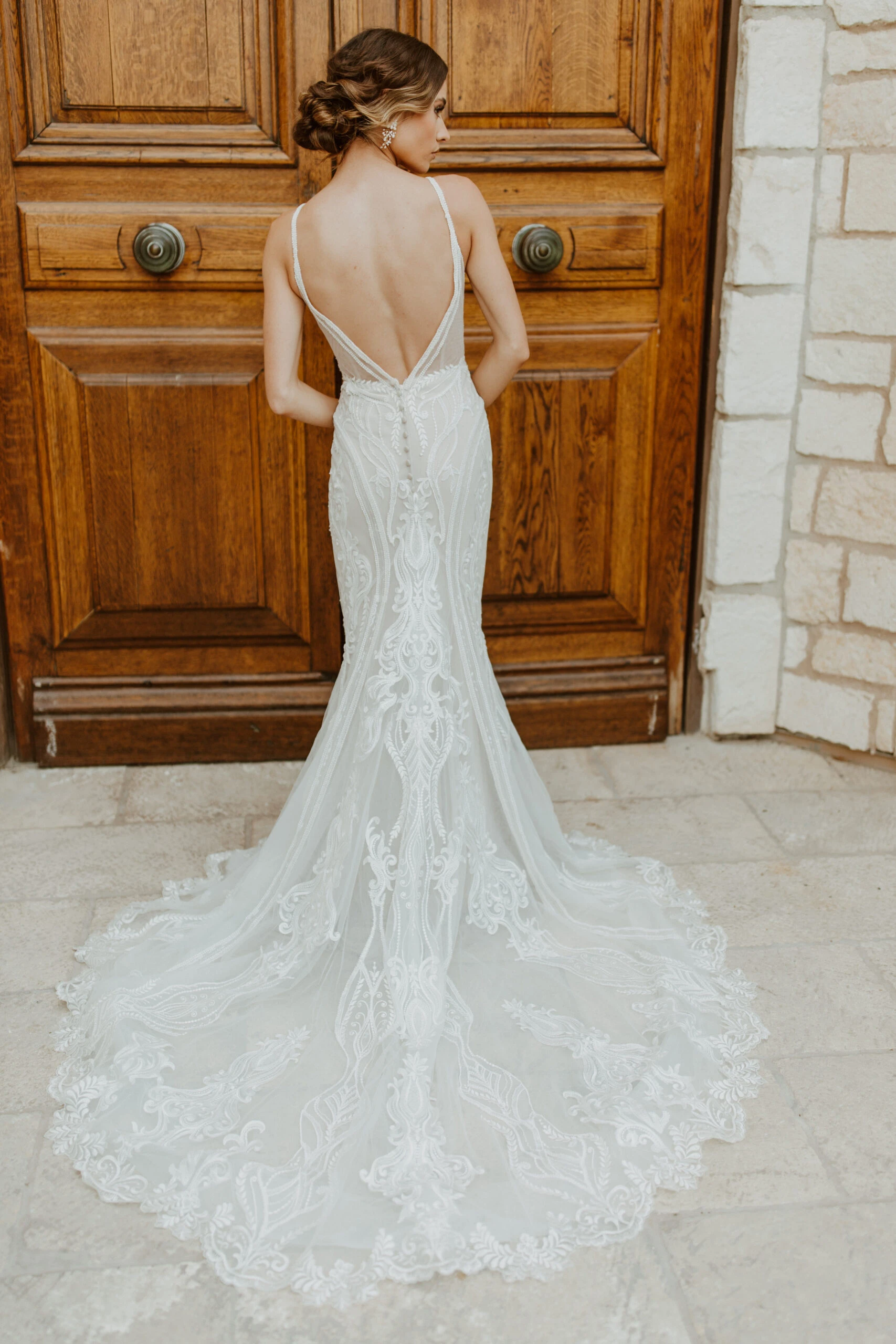 Bride showing the back of lace mermaid bridal gown