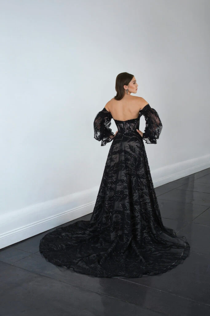 Back of bride wearing off the shoulder lace black wedding gown