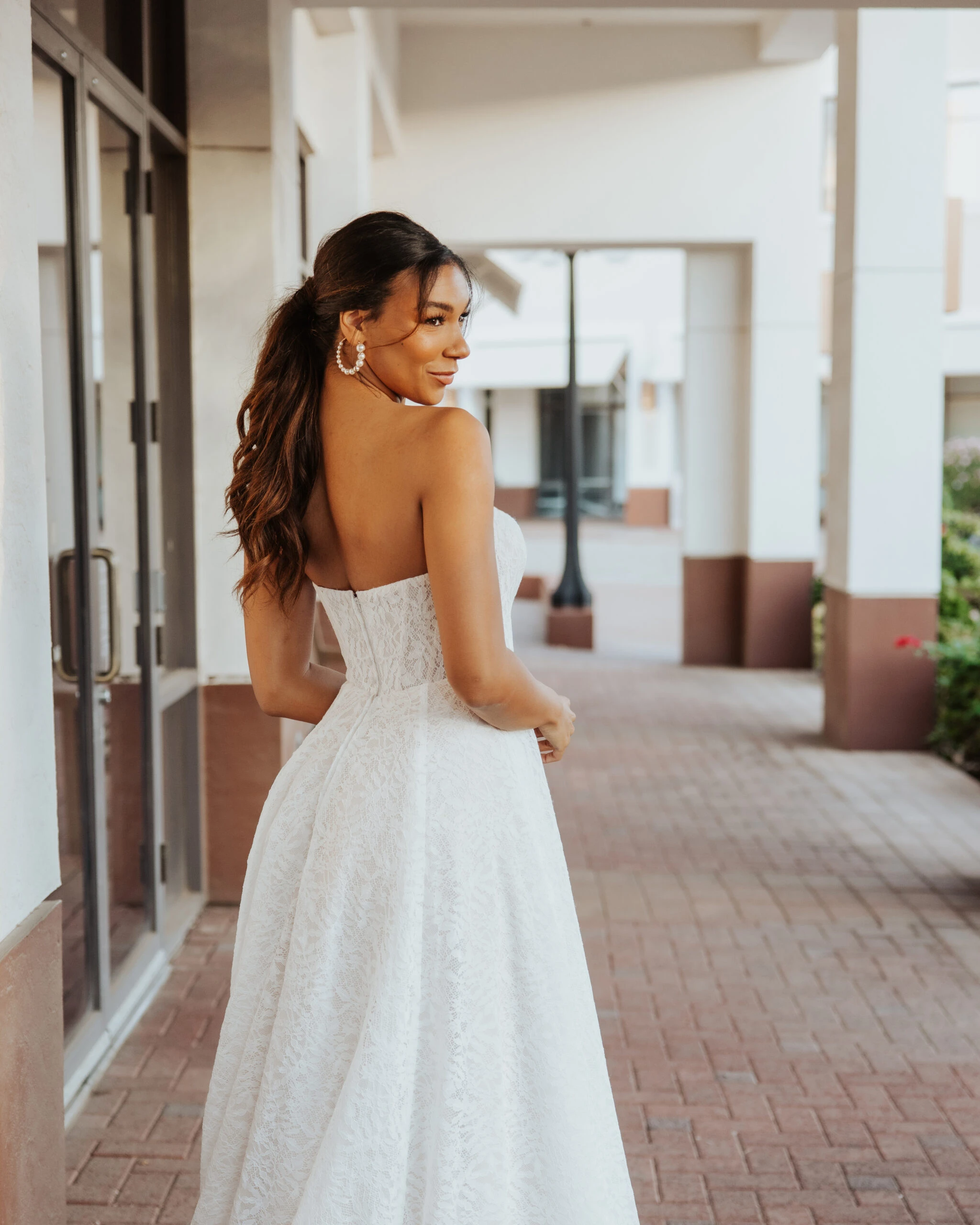 A Bride wearing a strapless sweetheart neckline wedding dress