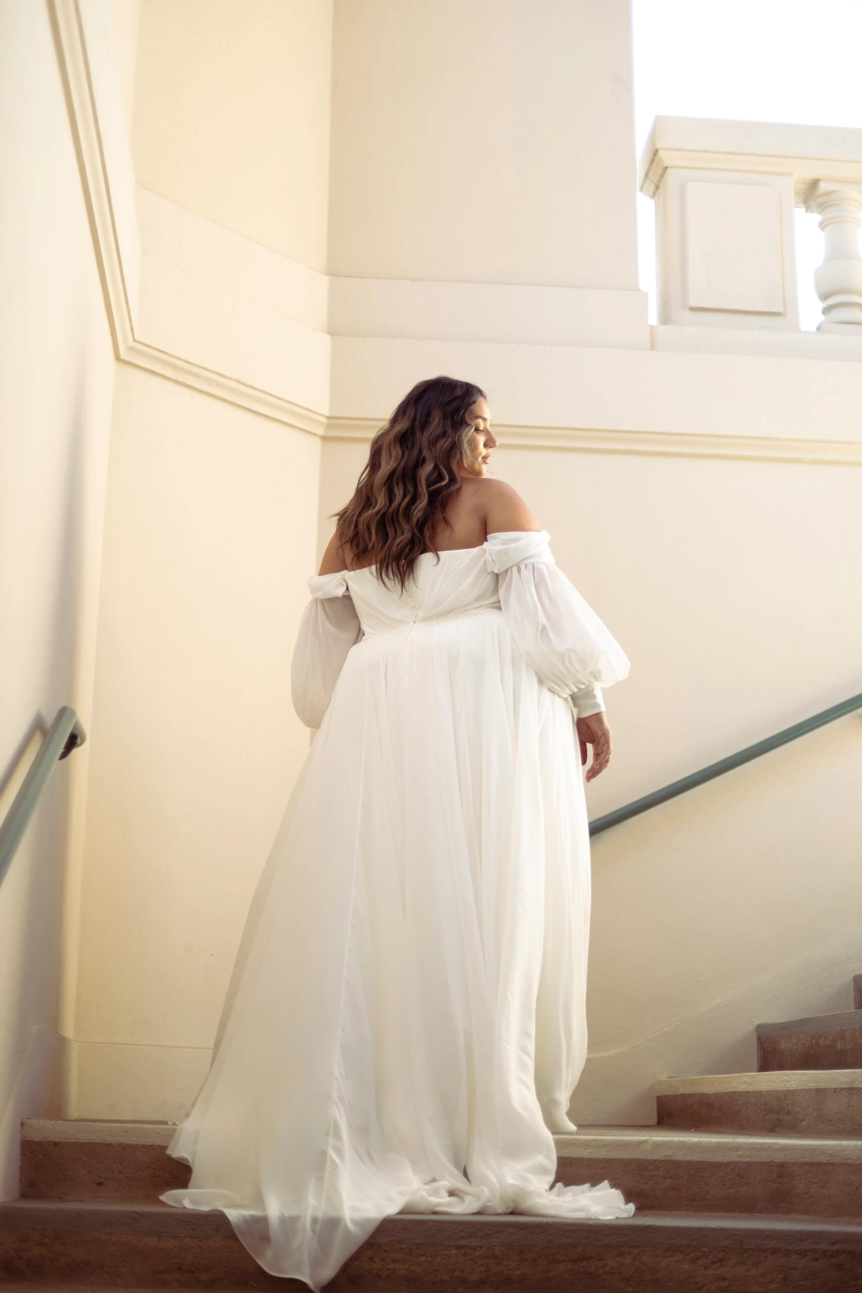 Back of Plus Size Bride wearing a long sleeve wedding gown