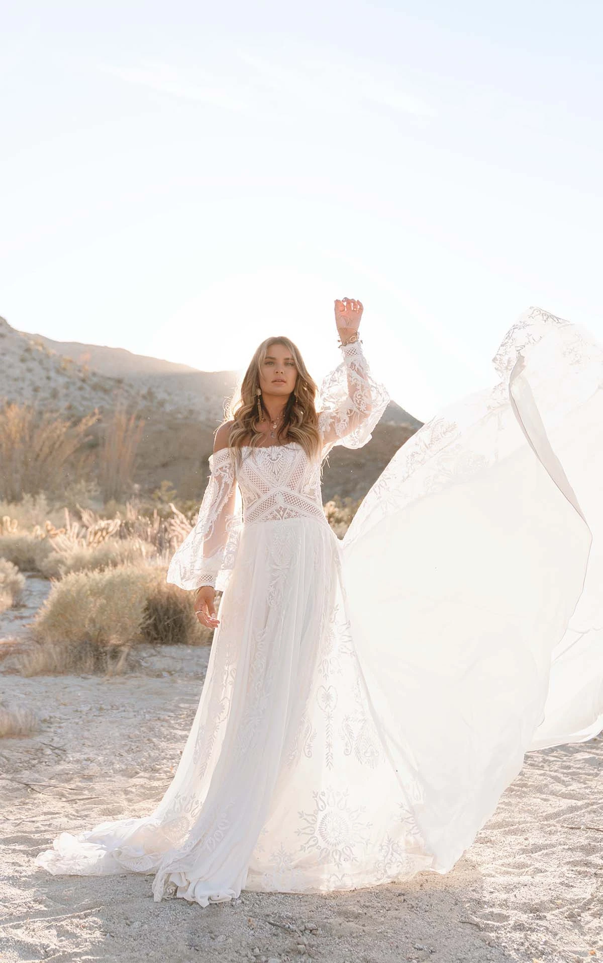 casual boho beach wedding dress with off the shoulder sleeves and flowy train - maddox by all who wander