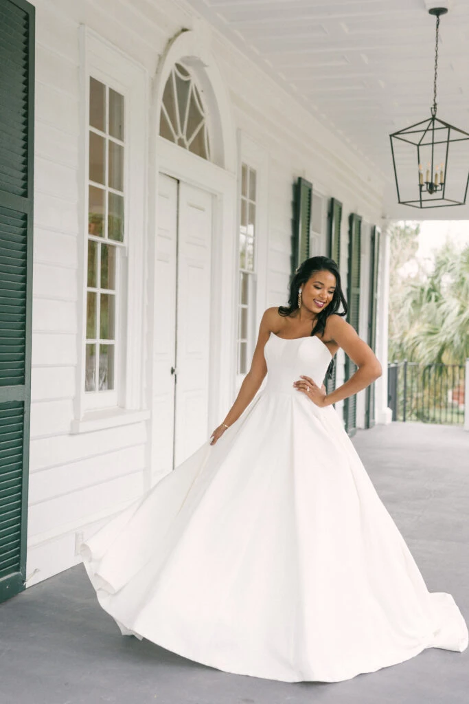 Bride wearing a strapless ballgown on a porch