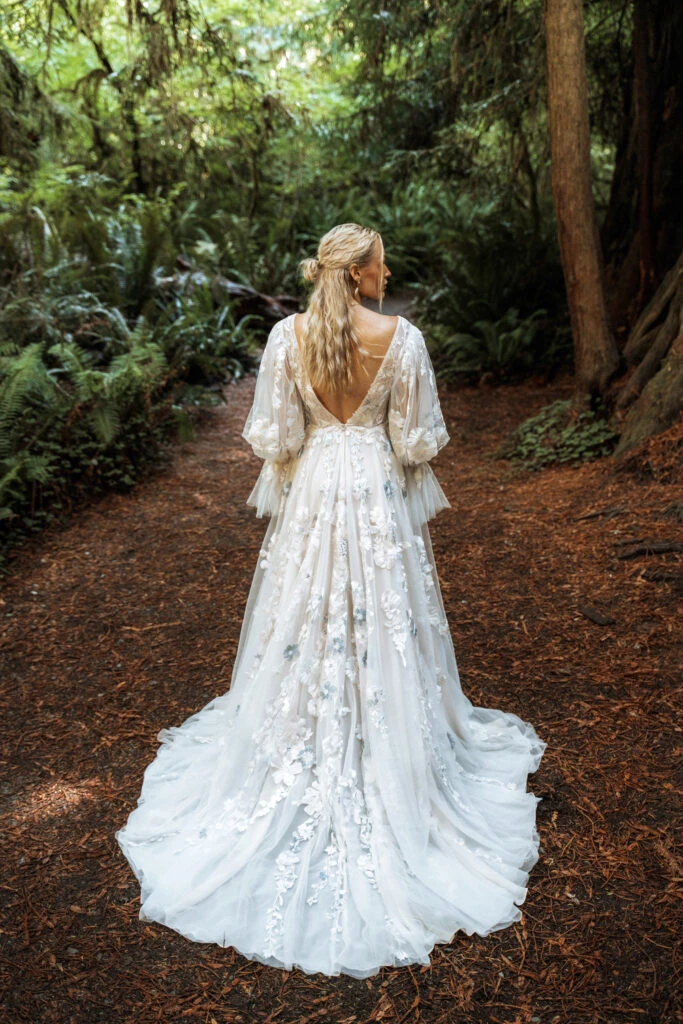 Back of Bride wearing long sleeve floral wedding dress